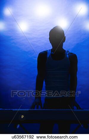 Silhouette of male musician on stage View Large Photo Image Stock Image - Silhouette of male musician on stage. Fotosearch
