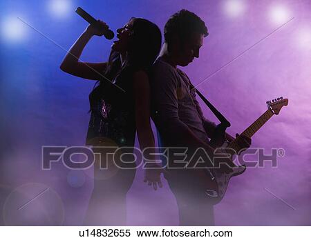 Silhouettes of singer and guitar player on stage View Large Photo Image Stock Photography - Silhouettes of singer and guitar player on stage. Fotosearch