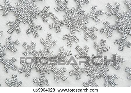 Stock Photo - Silver snowflakes on white background. Fotosearch