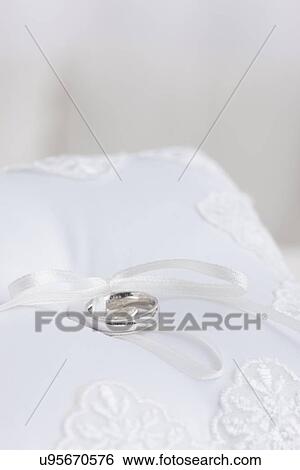 Silver wedding ring on white cushion View Large Photo Image Stock Photograph - Silver wedding ring on white cushion. Fotosearch