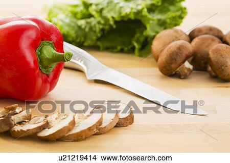 Picture - Sliced mushrooms and red pepper. Fotosearch