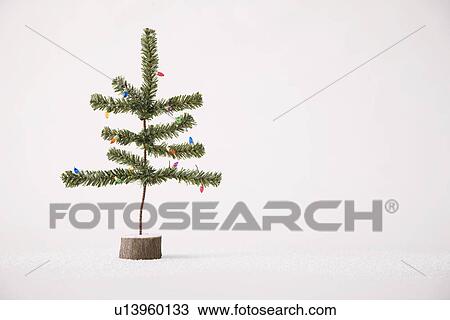 Stock Image - Small Christmas tree against white background. Fotosearch