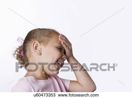 Smiling girl (6-7) touching forehead View Large Photo Image Stock Image - Smiling girl (6-7) touching forehead. Fotosearch