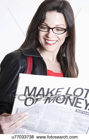 Stock Photo - Smiling woman reading newspaper. Fotosearch