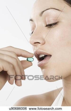 South Africa, Cape Town, close-up of young woman taking blue pill View Large Photo Image Stock Photograph - South Africa, Cape Town, close-up of young woman taking blue pill. Fotosearch