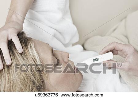 South Africa, Cape Town, Profile of sick young woman with thermometer in mouth View Large Photo Image Stock Photograph - South Africa, Cape Town, Profile of sick young woman with thermometer in mouth. Fotosearch