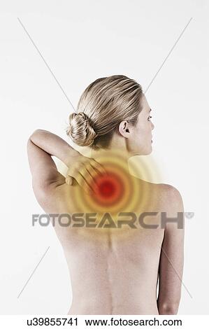 Stock Image - South Africa, Cape Town, Rear view of shirtless young woman touching neck. Fotosearch