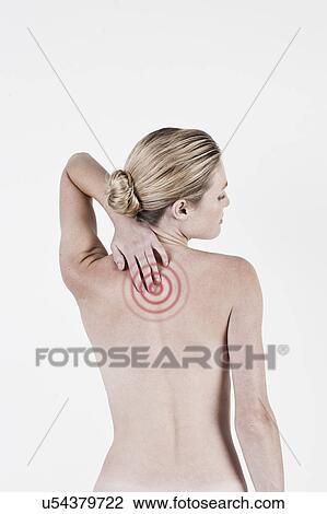 Stock Image - South Africa, Cape Town, Rear view of shirtless young woman touching neck. Fotosearch