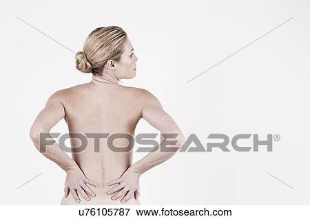 Stock Photo - South Africa, Cape Town, Rear view of shirtless young woman against white background. Fotosearch