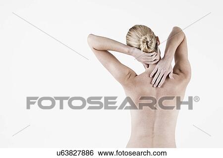 Stock Photograph - South Africa, Cape Town, Rear view of shirtless young woman touching neck. Fotosearch