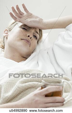 South Africa, Cape Town, Sick young woman lying in bed with tea View Large Photo Image Stock Image - South Africa, Cape Town, Sick young woman lying in bed with tea. Fotosearch