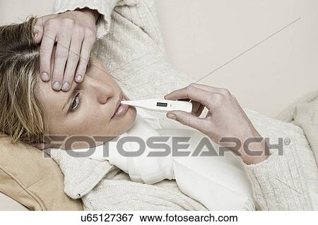 South Africa, Cape Town, Sick young woman with thermometer in mouth View Large Photo Image Stock Photo - South Africa, Cape Town, Sick young woman with thermometer in mouth. Fotosearch