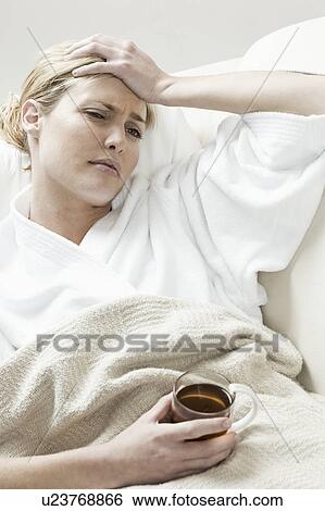 South Africa, Cape Town, Sick young woman lying in bed with tea View Large Photo Image Stock Photograph - South Africa, Cape Town, Sick young woman lying in bed with tea. Fotosearch