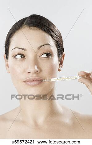 South Africa, Cape Town, Young woman holding thermometer in mouth View Large Photo Image Stock Image - South Africa, Cape Town, Young woman holding thermometer in mouth. Fotosearch