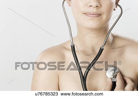 South Africa, Cape Town, Young woman examining self with stethoscope View Large Photo Image Stock Image - South Africa, Cape Town, Young woman examining self with stethoscope. Fotosearch