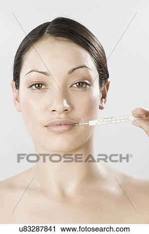 South Africa, Cape Town, Young woman holding thermometer in mouth View Large Photo Image Stock Image - South Africa, Cape Town, Young woman holding thermometer in mouth. Fotosearch