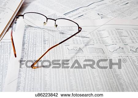 Spectacles on financial newspapers, close-up View Large Photo Image Stock Image - Spectacles on financial newspapers, close-up. Fotosearch