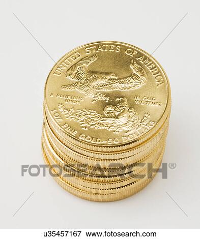 Stack of golden American coins on white background View Large Photo Image Stock Photo - Stack of golden American coins on white background. Fotosearch