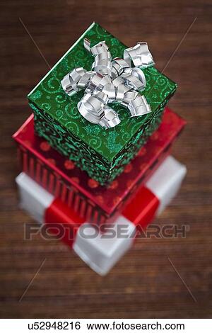Stack of presents with silver ribbon, directly above View Large Photo Image Stock Photograph - Stack of presents with silver ribbon, directly above. Fotosearch