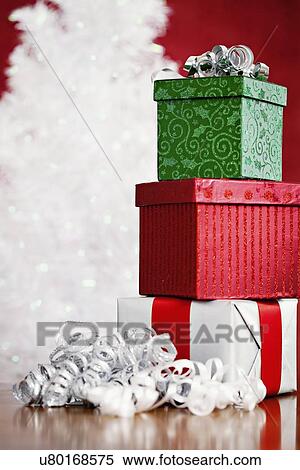 Stack of presents with silver streamer, studio shot View Large Photo Image Stock Photography - Stack of presents with silver streamer, studio shot. Fotosearch