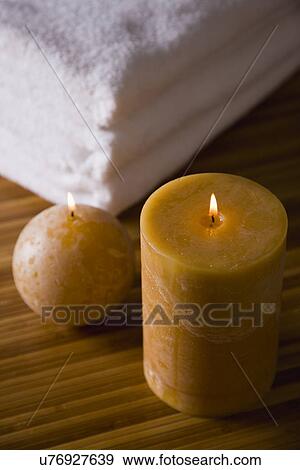 Stock Photo - Stack of towels and candles. Fotosearch