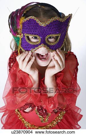 Picture - Studio portrait of girl (10-11) wearing costume and mask. Fotosearch