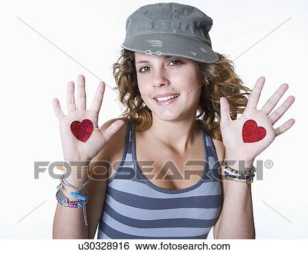 Studio portrait of smiling teenage girl (14-15) with heart drawn on hands View Large Photo Image Stock Photograph - Studio portrait of smiling teenage girl (14-15) with heart drawn on hands. Fotosearch