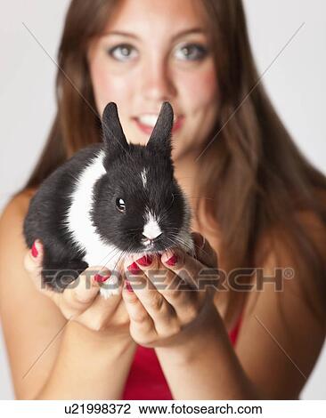 Studio portrait of teenage girl (14-15) holding small bunny View Large Photo Image Stock Image - Studio portrait of teenage girl (14-15) holding small bunny. Fotosearch