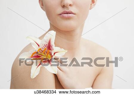 Studio portrait of woman holding flower View Large Photo Image Picture - Studio portrait of woman holding flower. Fotosearch