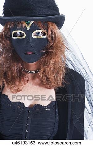 Studio portrait of woman wearing costume and mask View Large Photo Image Stock Image - Studio portrait of woman wearing costume and mask. Fotosearch