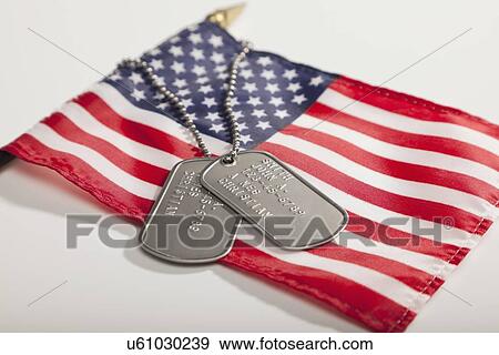 Stock Photo - Studio shot of American flag and dog tags. Fotosearch