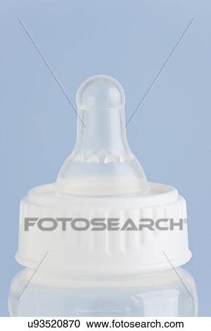 Studio shot of baby bottle on blue background View Large Photo Image Stock Image - Studio shot of baby bottle on blue background. Fotosearch