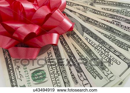 Stock Photo - Studio shot of banknotes and Christmas ornaments. Fotosearch
