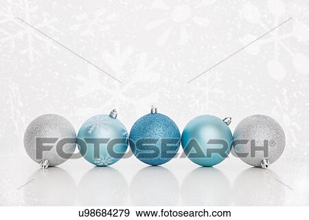 Studio shot of blue and white Christmas ornaments standing in row View Large Photo Image Stock Photo - Studio shot of blue and white Christmas ornaments standing in row. Fotosearch