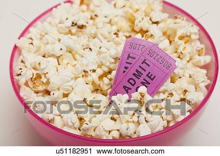 Studio shot of bowl of popcorn with movie tickets View Large Photo Image Stock Image - Studio shot of bowl of popcorn with movie tickets. Fotosearch
