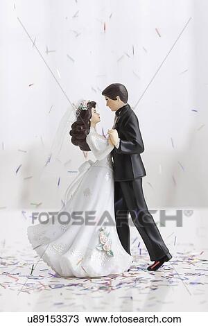 Stock Image - Studio shot of bride and groom figurines dancing. Fotosearch