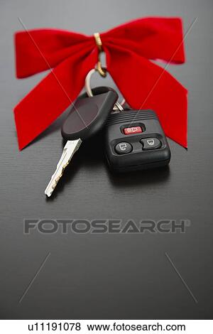 Studio shot of car key with red bow View Large Photo Image Stock Photo - Studio shot of car key with red bow. Fotosearch