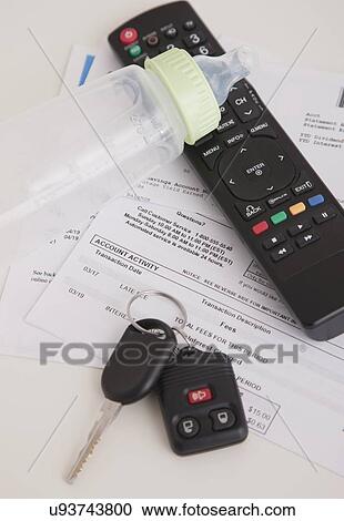 Stock Image - Studio shot of car keys, documents, remote control and baby bottle. Fotosearch