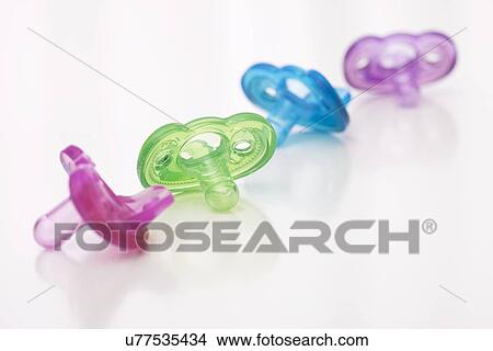 Studio shot of colorful pacifiers View Large Photo Image Picture - Studio shot of colorful pacifiers. Fotosearch