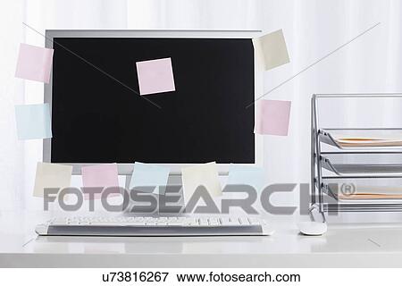 Stock Photo - Studio shot of desktop PC with adhesive notes. Fotosearch