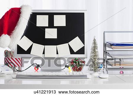 Stock Image - Studio shot of desktop PC with Christmas decorations. Fotosearch
