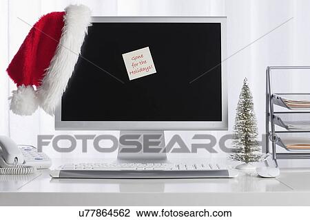 Stock Image - Studio shot of desktop PC with Christmas decorations. Fotosearch