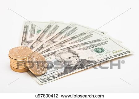 Stock Image - Studio shot of dollar bills and coins. Fotosearch