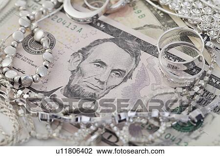 Studio shot of dollar bills and jewelry View Large Photo Image Stock Image - Studio shot of dollar bills and jewelry. Fotosearch
