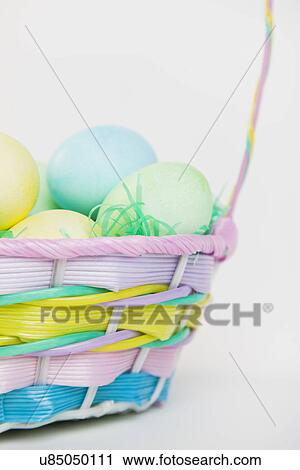 Studio shot of Easter eggs in basket View Large Photo Image Stock Image - Studio shot of Easter eggs in basket. Fotosearch