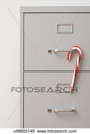 Stock Photo - Studio shot of filing cabinet with candy cane. Fotosearch