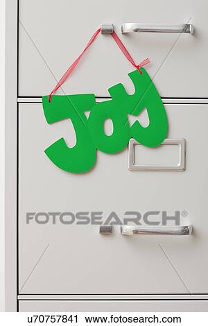 Studio shot of filing cabinet with word "Joy" hanging View Large Photo Image Stock Image - Studio shot of filing cabinet with word "Joy" hanging. Fotosearch