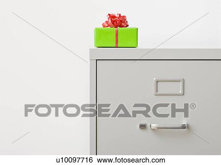 Stock Photograph - Studio shot of gift on top of filing cabinet. Fotosearch