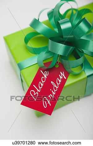 Stock Image - Studio shot of gift with Black Friday tag. Fotosearch