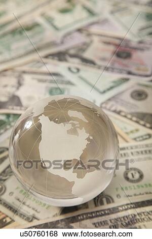 Studio shot of globe on banknotes View Large Photo Image Stock Photo - Studio shot of globe on banknotes. Fotosearch